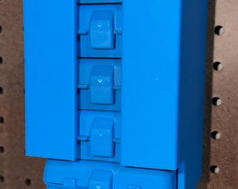 May include: A bright blue, wall-mounted storage unit with five compartments. Each compartment has a hinged lid with a secure latch. The unit is designed to hold small items, and is mounted on a pegboard.