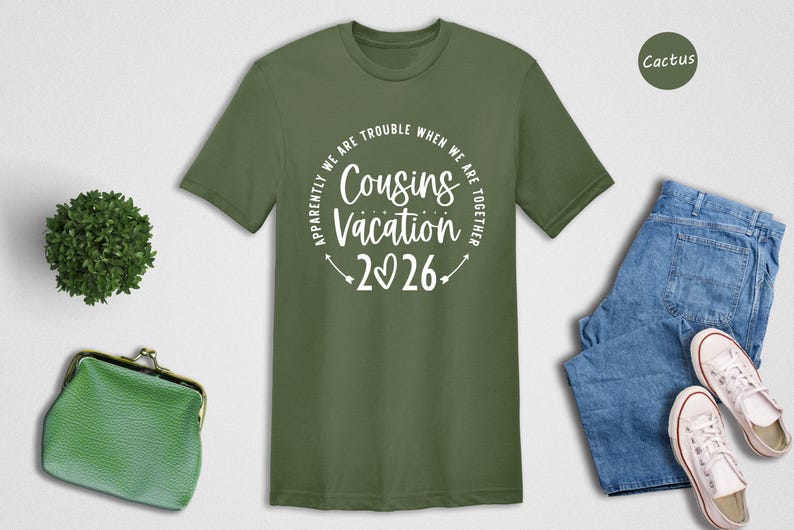 a green t-shirt with a humorous text, a pair of blue jeans, a pair of white sneakers, a green purse, and a small cactus plant.