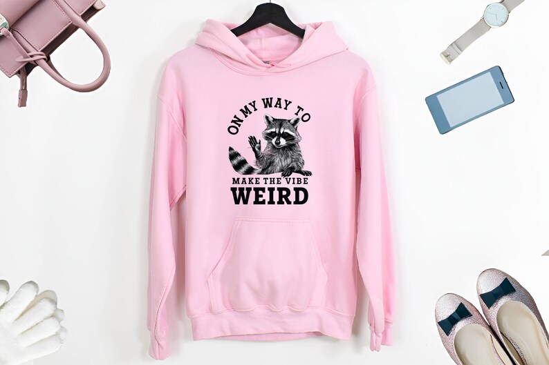 a pink hoodie with a raccoon on it