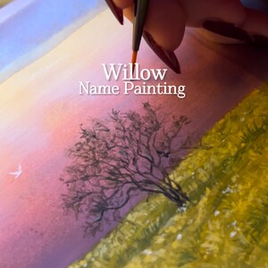 May include: A watercolor painting in progress, featuring a tree on a grassy hill under a pink and purple sky. The text "Willow Name Painting" is visible. A hand holds a paintbrush, adding details to the artwork.