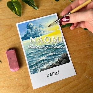 May include: A painting of a seascape with a large, fluffy white cloud in a blue sky. The sun is setting behind the cloud, casting a warm yellow glow on the water. The painting is signed "NAOMI Painting Names" and "NAOMI" at the bottom.