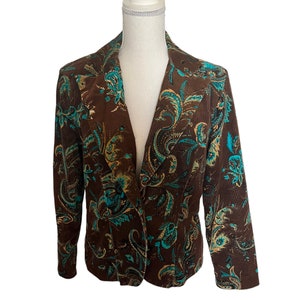 May include: A brown blazer with a paisley pattern in teal and gold. The blazer has a single button closure and long sleeves.