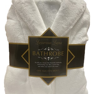 May include: White bathrobe with a black and gold label that reads "Luxurious Luna Bathrobe". The label also says "As soft as a cloud, this heavenly bathrobe will envelop you like a warm hug just when you need it the most. One size fits most!"