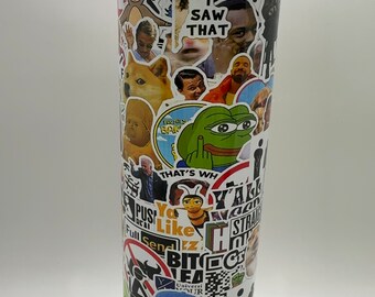 May include: A stainless steel tumbler covered in various meme stickers. The stickers include images of Doge, Pepe the Frog, and other internet memes. Text on the tumbler includes "I SAW THAT", "GIVE A FUCK", and "PLEASE WAIT".