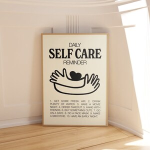 May include: A black and white printable poster with the text "DAILY SELF CARE REMINDER" and a simple illustration of two hands holding a heart. The poster lists 10 self-care tips.