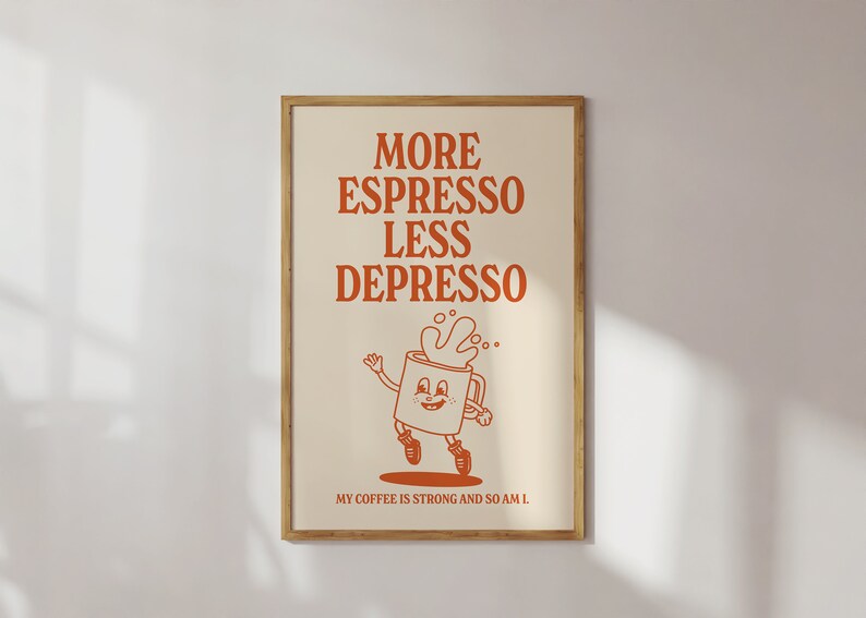 May include: A framed poster with the words "MORE ESPRESSO LESS DEPRESSO" in orange lettering. Below the text is a cartoon coffee cup character with a smiling face and running legs. The phrase "MY COFFEE IS STRONG AND SO AM I" is at the bottom.