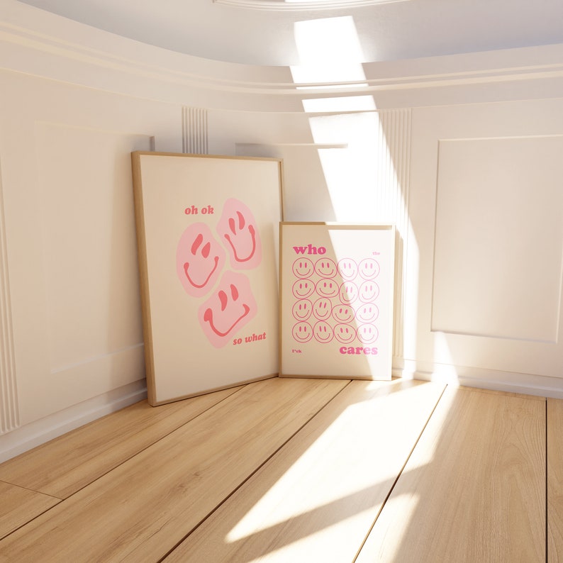May include: Two framed prints with pink smiley faces and text. The first print says "oh ok so what" and the second print says "who cares".