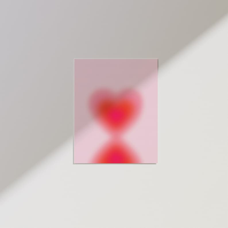 May include: A pink background with a blurry red heart shape in the center.