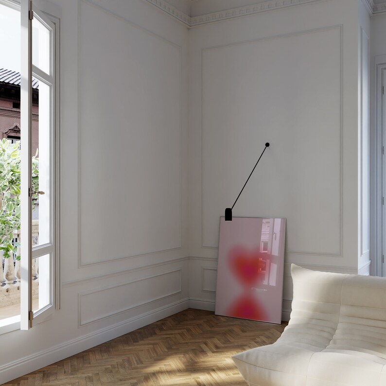 May include: A white room with a large window, a white couch, and a pink and red abstract painting hanging on the wall.