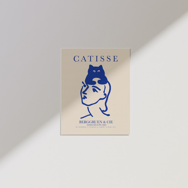 May include: A blue and white illustration of a woman with a cat sitting on her head. The text "CATISSE" is at the top of the image and "BERGGRUEN & CIE" is at the bottom. The text "PARIS, 70, RUE DE SEINE, PARIS" is below the company name.