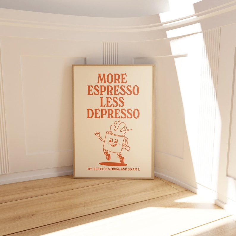 May include: A framed poster with the words "MORE ESPRESSO LESS DEPRESSO" in orange. Below the text is a cartoon coffee cup character. The text "MY COFFEE IS STRONG AND SO AM I" is at the bottom of the poster.