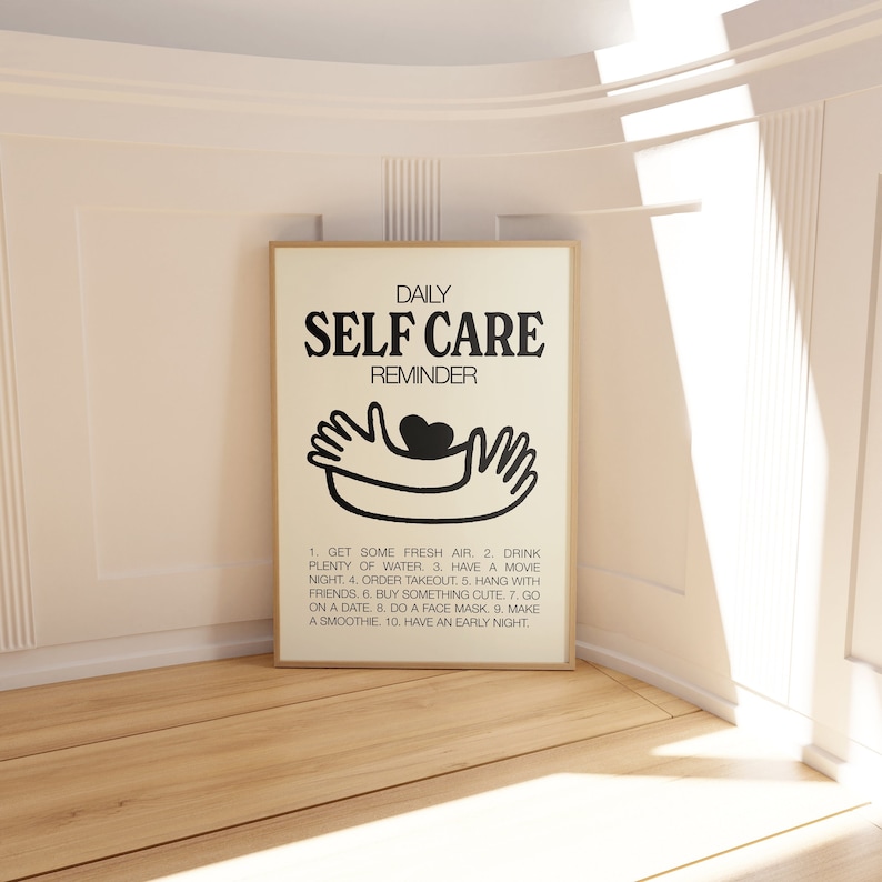May include: A black and white printable poster with the text "DAILY SELF CARE REMINDER" and a simple illustration of two hands holding a heart. The poster lists 10 self-care tips.