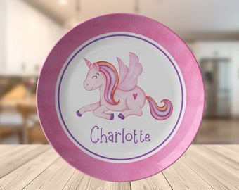 May include: Pink and purple children's plate with a watercolor unicorn design and the name Charlotte.