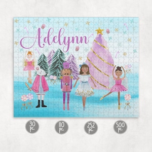 May include: A personalized jigsaw puzzle featuring a winter scene with a pink Christmas tree, a nutcracker, a mouse, and three ballerinas. The puzzle is titled "Adelynn" and is available in 30, 110, 252, and 500 pieces.