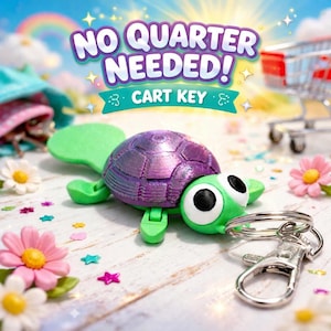 May include: A green and purple turtle-shaped cart key with a silver keyring. The key has large, cartoonish eyes and the text "NO QUARTER NEEDED! CART KEY" in a colourful design. Decorative flowers and stars surround the key.