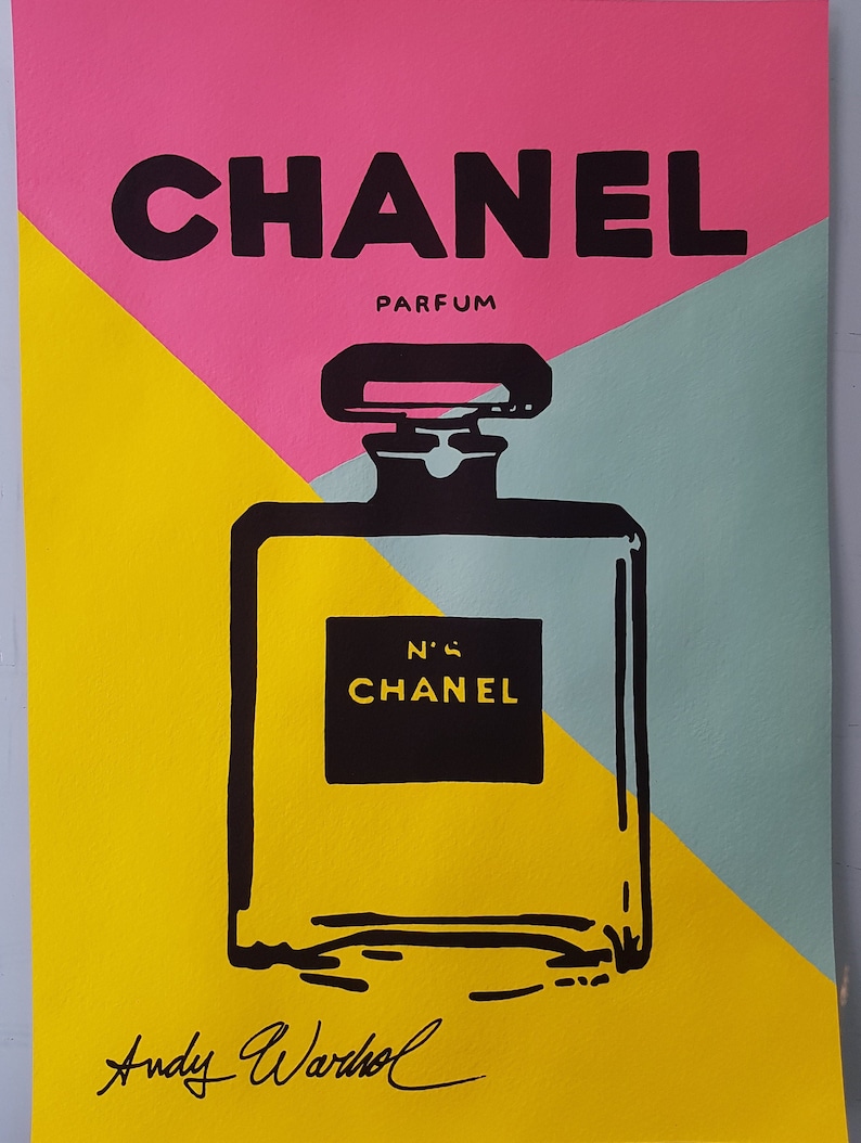 May include: A black and white illustration of a Chanel perfume bottle on a yellow, pink and blue background. The text "CHANEL PARFUM" and "N&deg;5 CHANEL" are visible. The image is signed "Andy Warhol".