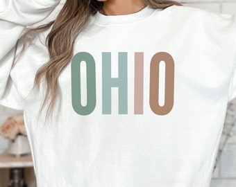 May include: White sweatshirt with the word "OHIO" printed in green, blue, pink, and brown.