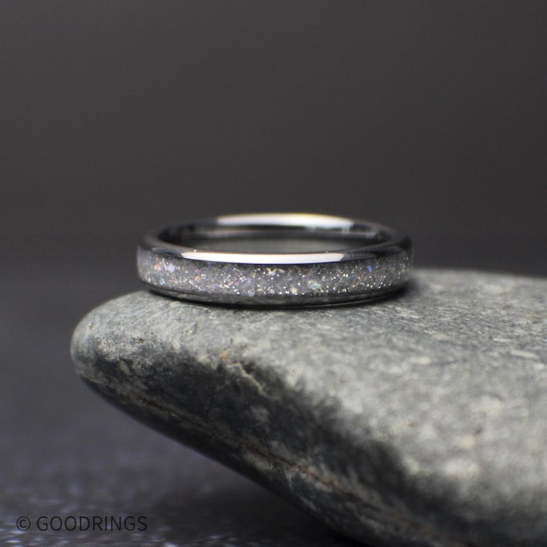 top view of minimalist 4mm moonstone band resting on stone highlighting subtle shimmer and comfort fit design