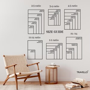 May include: A wall-mounted size guide for art prints, featuring various aspect ratios and dimensions in inches and centimeters. The guide includes 2:3, 3:4, 4:5, 11:14, and 1:1 ratios, along with A1-A4 sizes. A modern chair and side table are in the foreground.