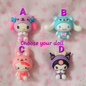 May include: Four colorful character dolls with different designs. The dolls are labeled A, B, C, and D. Choose your doll.