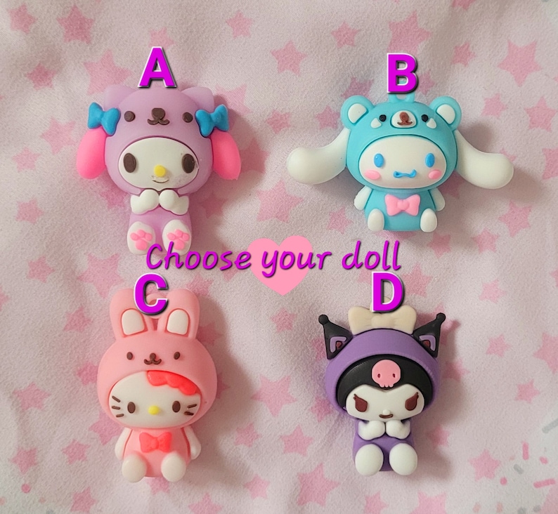 May include: Four colorful character dolls with different designs. The dolls are labeled A, B, C, and D. Choose your doll.