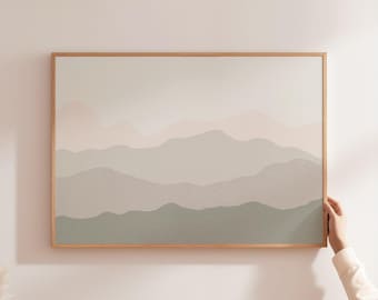 Puede incluir: Una impresión de arte mural rectangular que presenta un paisaje montañoso en capas con tonos suaves y apagados de verde salvia, beige y crema. La obra está enmarcada en un marco de madera fina de color claro, con líneas horizontales onduladas.