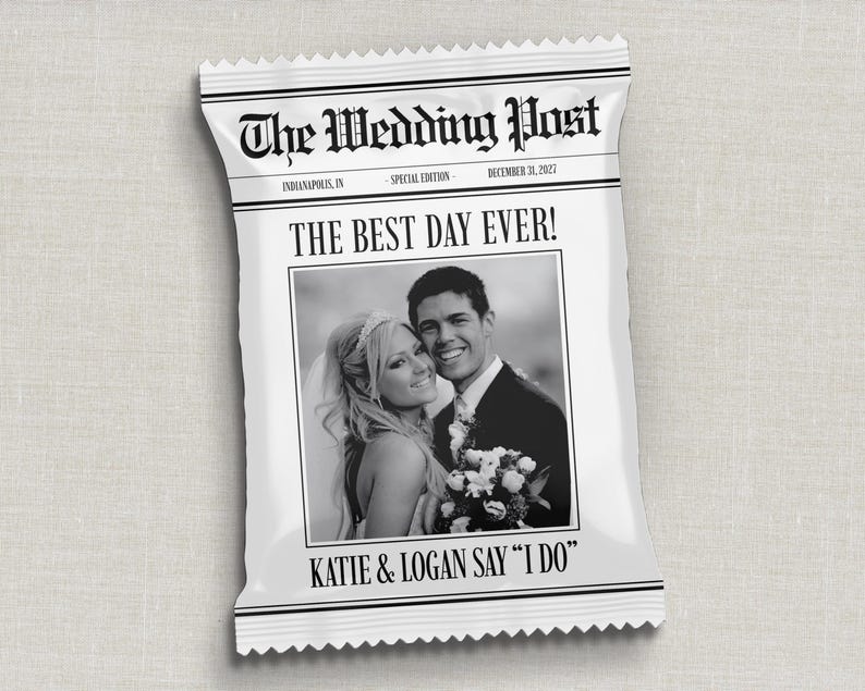 May include: A white packet resembling a newspaper, with the headline "The Wedding Post." It displays a black and white photograph of a smiling couple and the text "THE BEST DAY EVER!" and "KATIE & LOGAN SAY 'I DO'" in black.