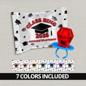 May include: A white candy wrapper with the text "CLASS RING 2026 CONGRATULATIONS!" and graduation cap graphics. A red ring pop with a blue base sits next to the wrapper. The image also shows 7 color variations.