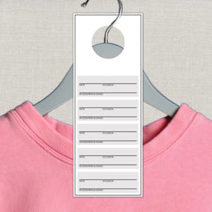 May include: A rectangular white clothing tag hanging from a gray hanger over a pink garment. The tag features five repeating sections with horizontal lines for date and occasion, and a printed line labeled accessories and shoes in black text.