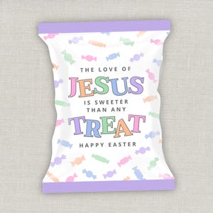 May include: A white candy bag with a purple top and bottom border, decorated with pastel-colored candies. The text reads "THE LOVE OF JESUS IS SWEETER THAN ANY TREAT HAPPY EASTER" in colorful letters.