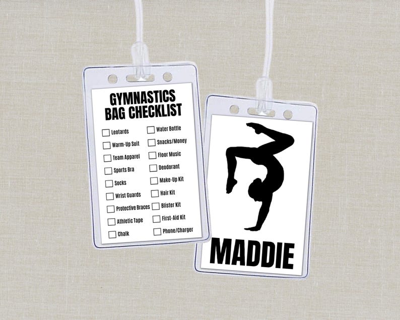 May include: Two clear plastic ID holders with white lanyards. One has a gymnastics bag checklist, the other a gymnast silhouette and the name "MADDIE". The checklist includes items like leotards and water bottles.