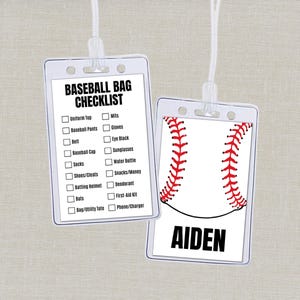 May include: Two clear plastic baseball bag tags. One tag displays a baseball bag checklist, including items like uniform top, socks, and batting helmet. The other tag features a baseball design with the name "AIDEN" in bold black letters.