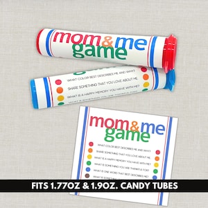 May include: Two cylindrical white plastic candy tubes with red and blue caps, featuring the text "mom & me game" and colorful dots. A square card displays the same title, a list of questions, and colored dots. The tubes fit 1.77oz and 1.90oz sizes.
