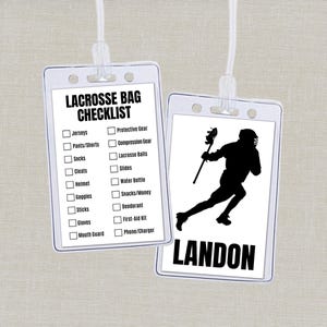 May include: Two clear plastic badge holders with white cords. One has a lacrosse bag checklist, the other a black silhouette of a lacrosse player and the name "LANDON". The checklist includes items like jerseys, cleats, and a water bottle.
