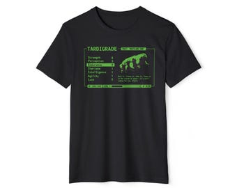 May include: Black t-shirt featuring a green graphic of a Tardigrade, with stats and the text "Tardigrade - Wasteland Tank". The design includes a pixelated image of the creature and text in a retro video game style.