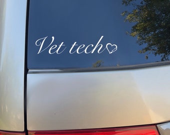 May include: A white vinyl sticker on a silver car with the text "Vet tech" and a small heart symbol.