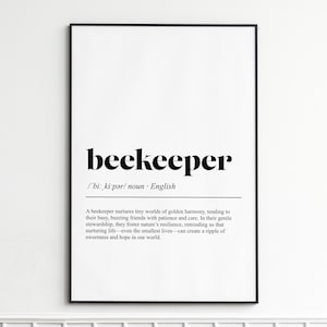 May include: A framed print with the word "beekeeper" in bold black font. Below the word is the phonetic pronunciation and the word "noun". The definition of beekeeper is printed below the line in black font.