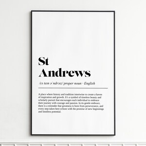 May include: A framed print with the text "St Andrews" in a bold, elegant font. Below the name is a definition and a description of the place. The print is in black and white.