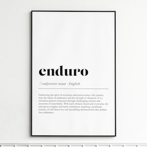 May include: A framed print featuring the word "enduro" in bold black lettering. The definition, in smaller black text, explains endurance and perseverance. The print is set against a white background, with a black frame.