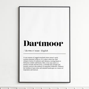 May include: A framed print with the word "Dartmoor" in bold black font. Below the word is the phonetic pronunciation and the word "noun". The text describes the moorland's beauty and tranquility.