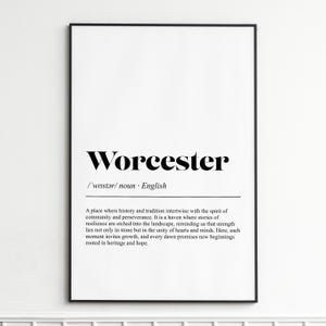 May include: A framed print with the word "Worcester" in a bold, black serif font. Below, the definition includes pronunciation and a description of the city's history and community spirit. The frame is black.