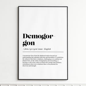 May include: Black framed art print with the word "Demogorgon" in bold black font. Below the word is the phonetic pronunciation and the word "noun". The text describes a mysterious force embodying fear and fascination.