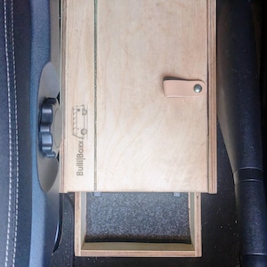 May include: A wooden drawer organizer with a gray felt lining. The drawer is labeled "BullBoxx" and has a leather strap handle.