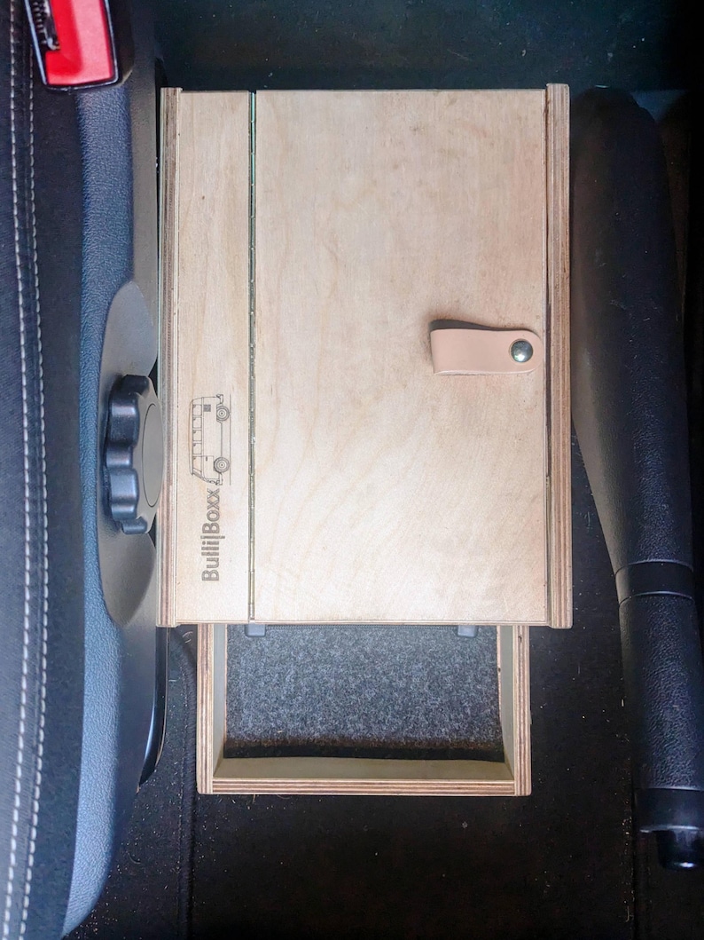 May include: A wooden drawer organizer with a gray felt lining. The drawer is labeled "BullBoxx" and has a leather strap handle.