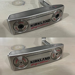 May include: A silver Kirkland Signature putter with a red logo and black accents. The putter has a milled face and a black grip.