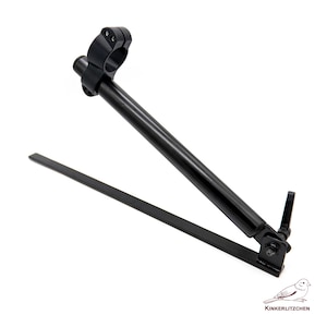 May include: A black metal camera accessory with a circular clamp, a long angled arm, and a flat base. The accessory is designed to hold a camera or other equipment. The item is on a white background.