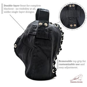 May include: Black, double-layered blackout hood with silver eyelets and snaps. Features a removable top grip for adjustable use. Text on the image reads: "Double-layer front for complete blackout - no visibility at all, unlike single-layer designs."