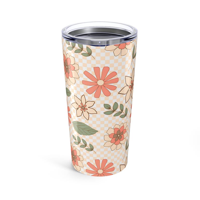 May include: A stainless steel tumbler with a checkered pattern and a floral design in shades of peach, cream, and green.