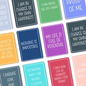 May include: A set of 10 colorful affirmation cards with positive messages. The cards feature white text on a variety of colored backgrounds, including blue, green, pink, and yellow. The messages include "I am in charge of my own happiness", "Nothing is impossible", "My life is full of potential", and "I only run out of chances when I stop trying".