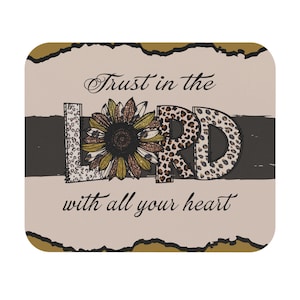 May include: A beige background with a brown and black stripe. The word "LORD" is in large letters with a sunflower and leopard print design. The text "Trust in the LORD with all your heart" is written in cursive.